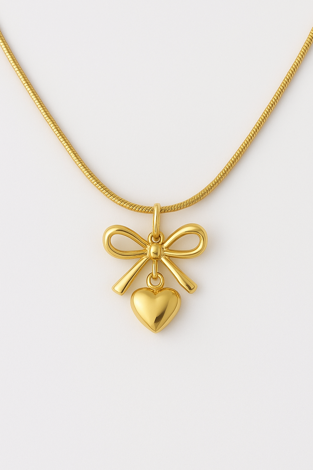 Femmora Elegant Bow & Heart Pendant Gold-Toned Necklace